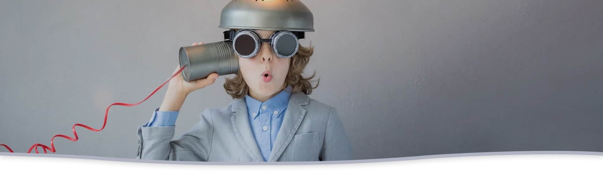 A child with welding goggles holding a lightbulb