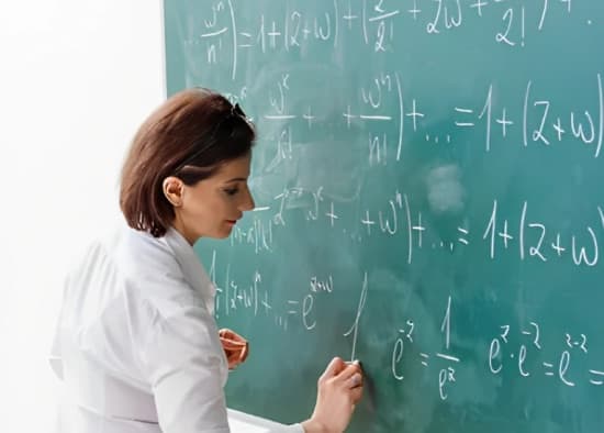 A teacher lecturing at a chalkboard